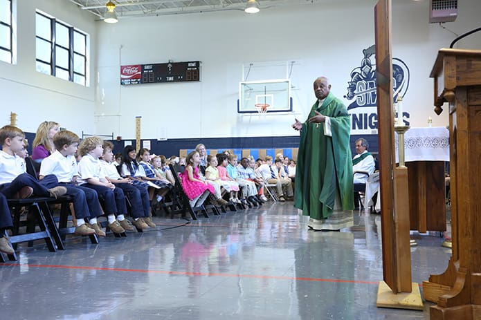 Archbishop Wilton D. Gregory, standing right, was the main celebrant and homilist for the Sept. 1 Mass marking the 70th anniversary of St. Maryâs School. Photo By Michael Alexander