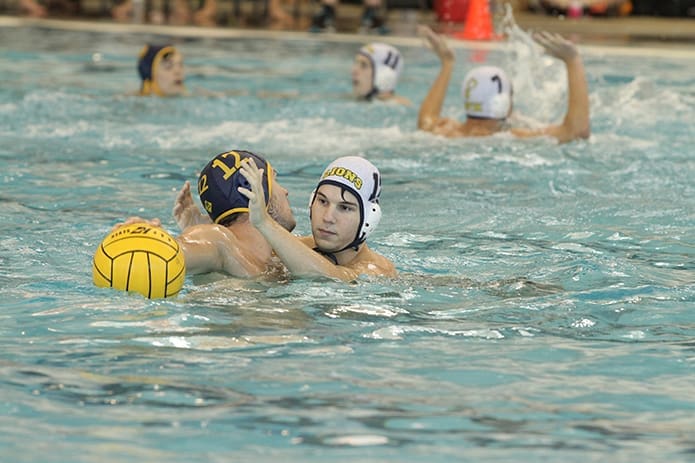 St. Pius X senior Robert Benoit, facing camera, plays defense against one of the players on the Wheeler High School Wildcats A-team. Photo By Michael Alexander