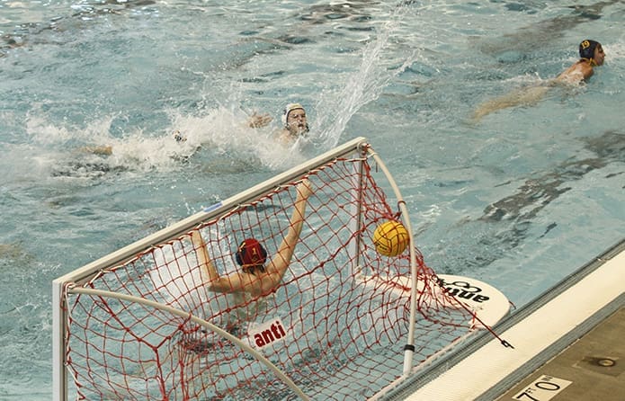 Senior center forward and utility player Tim Beck, top center, scores St. Pius’ 20th goal just before the end of the third period during the team’s second round match. Photo By Michael Alexander