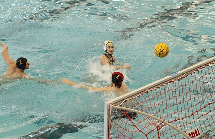 Senior utility player Carolina Benoit, top center, scores as the opposing goalkeeper finds himself out of position. It was St. Pius’ final goal in its 23-1 defeat of the Wheeler High School Wildcats. Carolina, 17, plays on the team with her twin brother, Robert. Photo By Michael Alexander