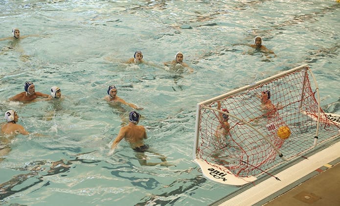 Junior center forward Connor McGee (#3, bottom left) scores one of his two, second half goals. He also had two in the first half to lead the team’s well-balanced offense. Photo By Michael Alexander