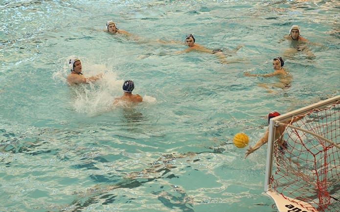 Chatfield (#2, top left) scores the team’s 12th and final goal in its 12-4 win over their archrival, the Blue Devils of Norcross. Photo By Michael Alexander