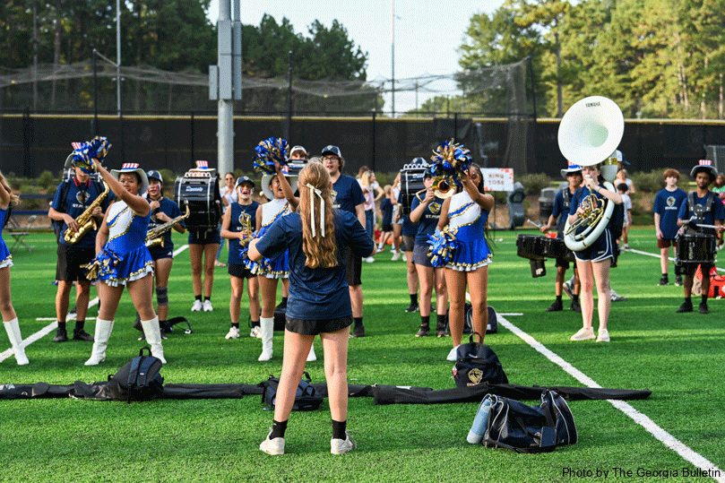 The 23 members of the Marching Golden Lions face their drum major Zoe Leiner, a senior.  Photo by Julianna Leopold