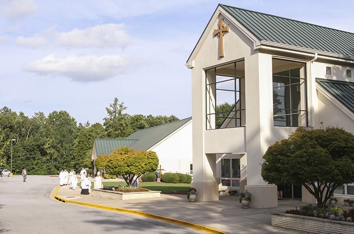 Clergy make their way from the Parish Life Center to St. Theresa of the Child Jesus Church for the celebration of a Mass marking the 30th anniversary of the Douglasville parish Aug. 7. Photo By Michael Alexander