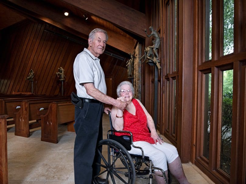 Longtime members Bill and Franna Keeling are photographed inside the sanctuary at St. Thomas Aquinas Church in Alpharetta. Photo by Johnathon Kelso