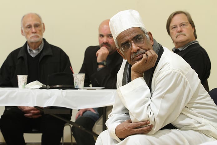 Dr. Moiz Mumtaz, foreground, the executive committee president for the Islamic Center of North Fulton served as the official host for the tour around the Center and the discussion on Islam. The St. Thomas Aquinas Church parishioners listening in the background include (l-r) Tom Horst, Gerard LaHatte and Eric Regan. St. Thomas Aquinas and the Islamic Center of North Fulton occupy the same road in Alpharetta, almost 1.5 miles from each other. Photo By Michael Alexander