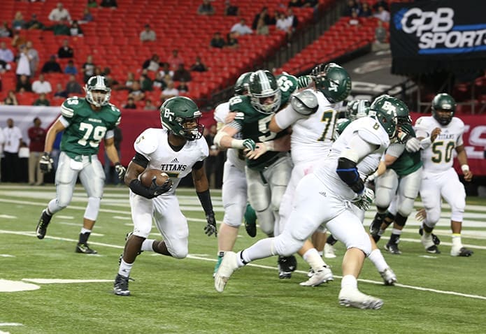 Blessed Trinity High School senior running back Milton Shelton (#5) follows his lead blocker, senior fullback Jake Bogosian (#38) as the team drives deep into Westminster territory. Quarterback Conor Davis would eventually score a on 1-yard touchdown to give Blessed Trinity a 31-17 lead with 6:25 remaining in the fourth quarter. Photo By Michael Alexander