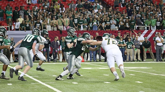 Blessed Trinity defensive linemen Kyle Molter (#77, left) and Michael Byars (#72, right) pursue Westminster quarterback Rankin Woley (#12) before they sack him in the third quarter. Photo By Michael Alexander