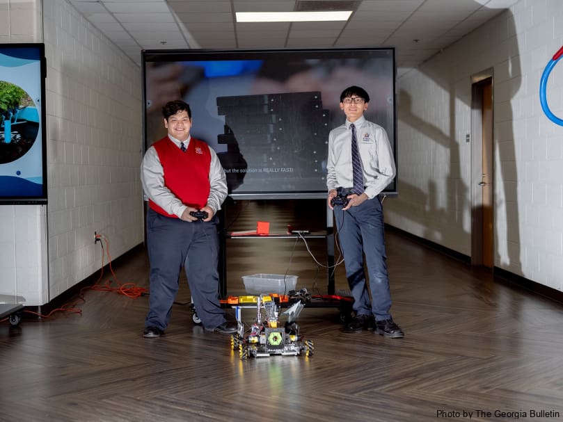 Keaton Garcia and Henry Nguyen display their robotics skills during a Stem Showcase held at St. Mary's Academy. Photo by Johnathon Kelso