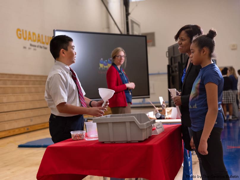Seventh-grader Francois Dang explains a chicken feeder design to guests at the Stem Showcase held at St. Mary's Academy. Photo by Johnathon Kelso