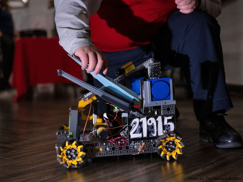 Keaton Garcia prepares to launch a paper airplane from a creation made in the 8th-12th grade robotics program during the STEM Showcase at St. Mary's Academy in Fayetteville. Photo by Johnathon Kelso