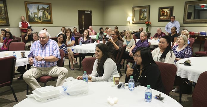 Archdiocesan employees listen to the summer concert performers on the terrace level of the Archdiocese of Atlanta’s Chancery. Desserts and nonalcoholic beverages were provided during the performance. Photo By Michael Alexander
