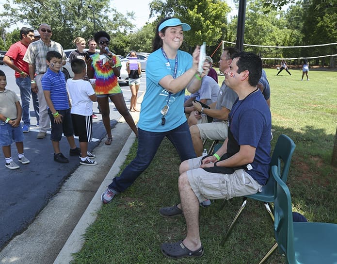 Parishioners like Rosemary York made donations of $10 so they could throw a cream pie at the pastor, Father Ignacio Morales, Zach Schlag, Deacon Frank Przybylek or Deacon Johnny Rentas. Photo By Michael Alexander