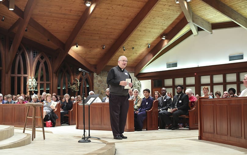 As host of the ninth annual Alpharetta Community Thanksgiving Service, Msgr. Dan Stack, pastor of St. Thomas Aquinas Church, gives some closing remarks. Photo By Michael Alexander
