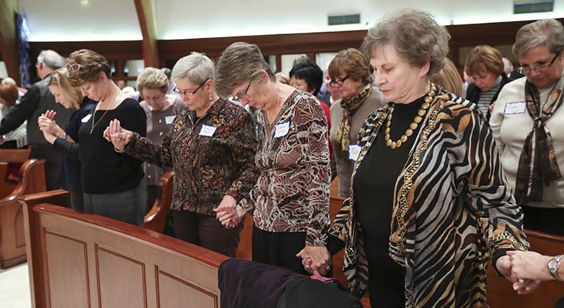 Members of the congregation join hands throughout the church for the final prayer and blessing. Photo By Michael Alexander