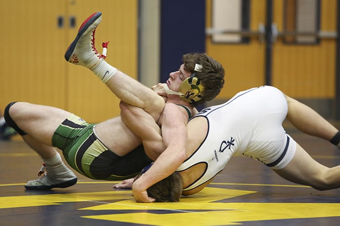 Biceps and a leg meet in this Catholic Duals match last year between Daniel Fulcher of Blessed Trinity, left, and Max Spearman of St. Pius X. Photo By Michael Alexander
