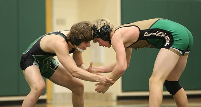 Wrestling combatants Joey Brinsmaid of Blessed Trinity, left, and Jimmy Dinsmore of Pinecrest Academy size each other up in their Jan. 17 match at 132 pounds. Photo By Michael Alexander