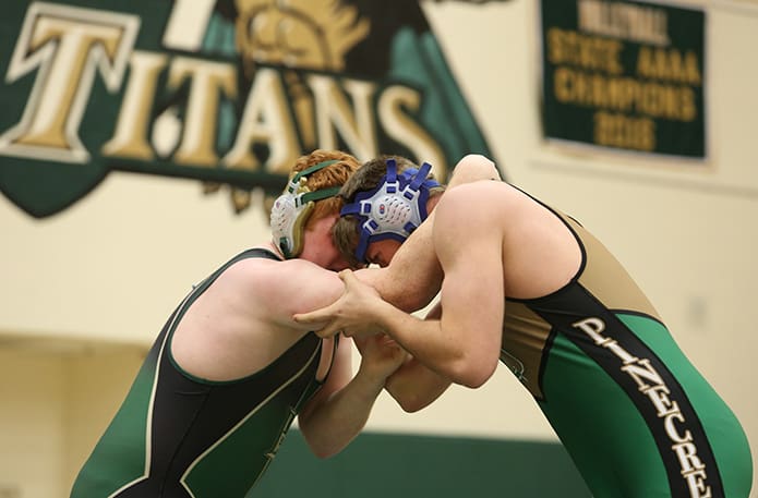 John Jacobs of Blessed Trinity, left, and Alexander Fabian of Pinecrest Academy feel each other out in the early stages of their 220-pound weight division match on January 17. Photo By Michael Alexander