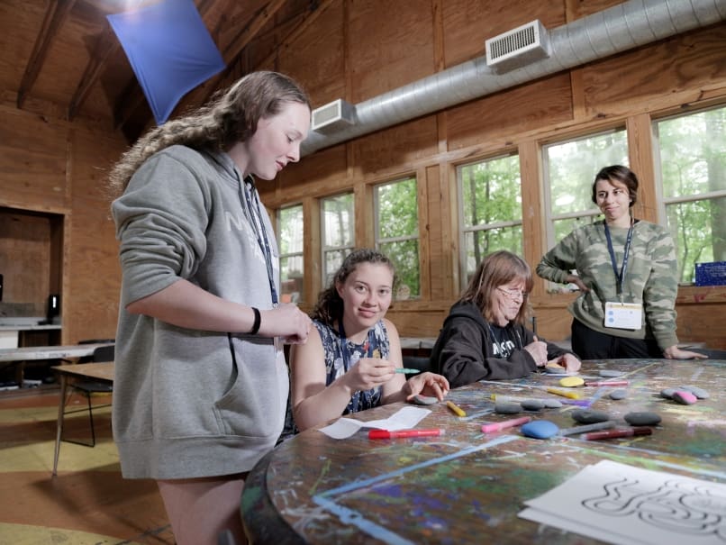 Camper Mia Newman, center, participates in art activities at Toni's Camp. To her left  is counselor Kaelyn King. Photo by Johnathon Kelso