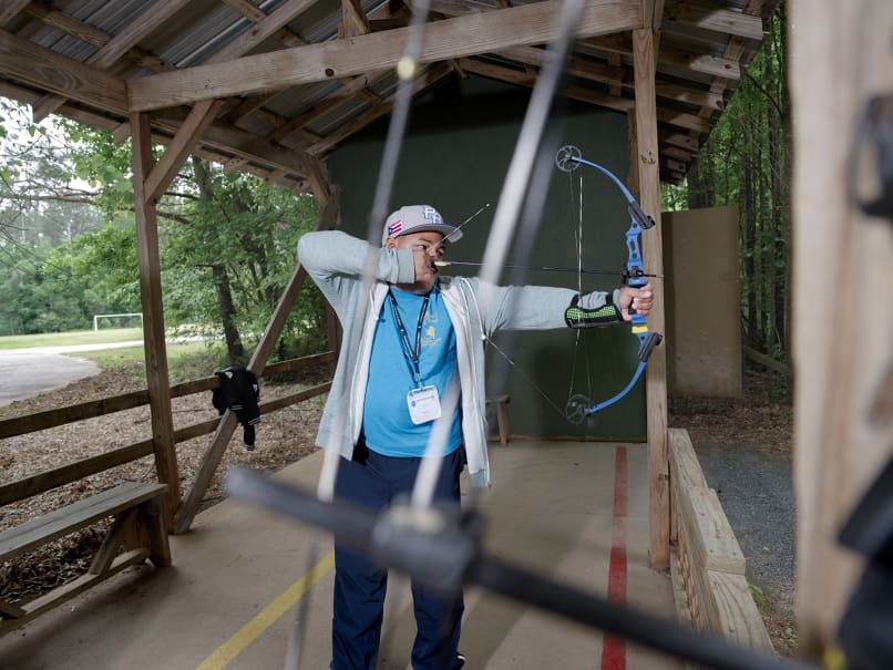Sammy Quiñones practices archery at Toni's Camp in Rutledge. The camp is a program of the Disabilities Ministry of the Archdiocese of Atlanta. Photo by Johnathon Kelso