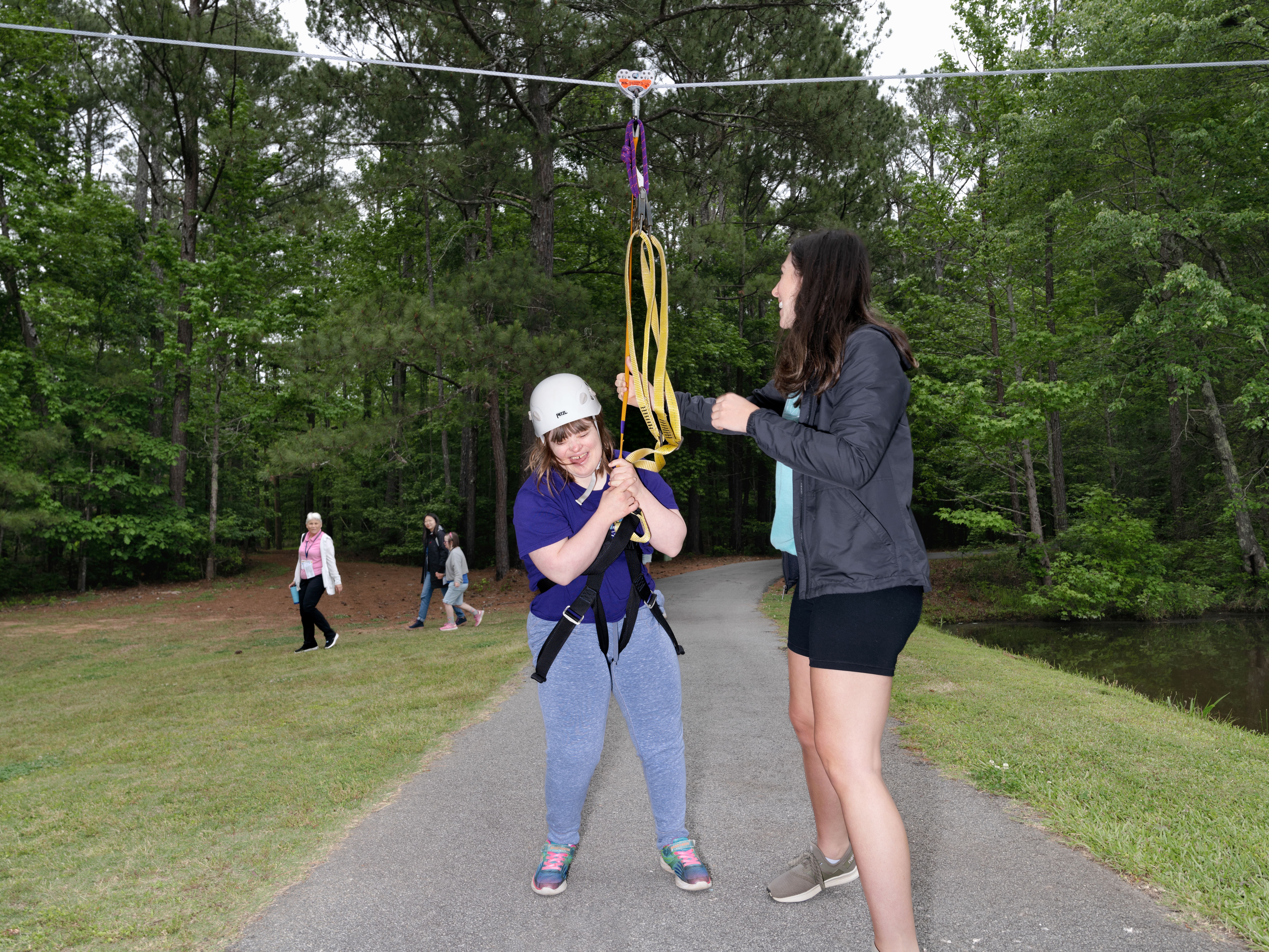 Camper Deb Curry ends her run on the zipline during Toni's Camp in Rutledge. Photo by Johnathon Kelso