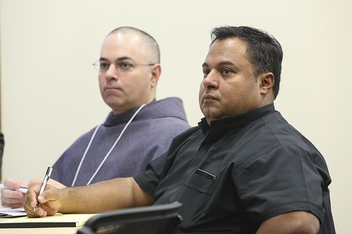 Franciscan Father Vincent Rubino, left, parochial vicar at Blessed Sacrament Church, Burlington, N.C., and Fr. Bill John Acosta Escobar, pastor of St. Therese Church, Wilson, N.C., learn about establishing finance and parish councils in a parish. Photo By Michael Alexander
