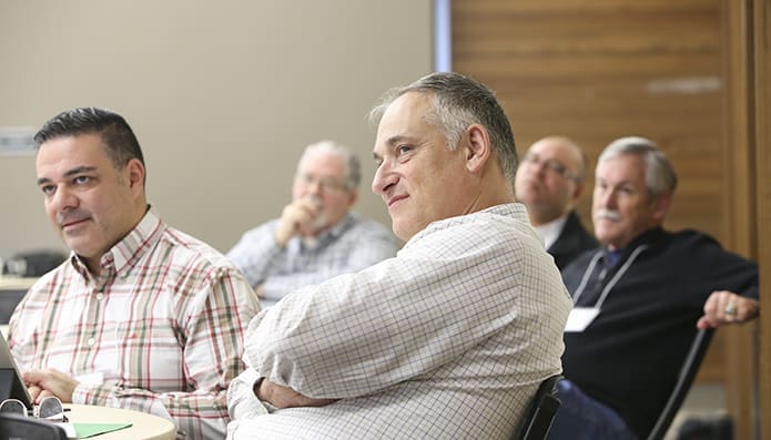 Msgr. James Schillinger, foreground center, director of Ongoing Formation of Priests for the Archdiocese of Atlanta, and Father John DeSousa of the Archdiocese of Newark, left, sit among the participants during a Nov. 14 session of the Toolbox for Pastoral Management. Photo By Michael Alexander