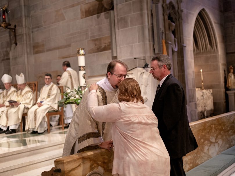Deacon Matthew Howard embraces his mother after donning the diaconal vestments for the first time during the Rite of Ordination to the diaconate held at the Cathedral of Christ the King. Photo by Johnathon Kelso