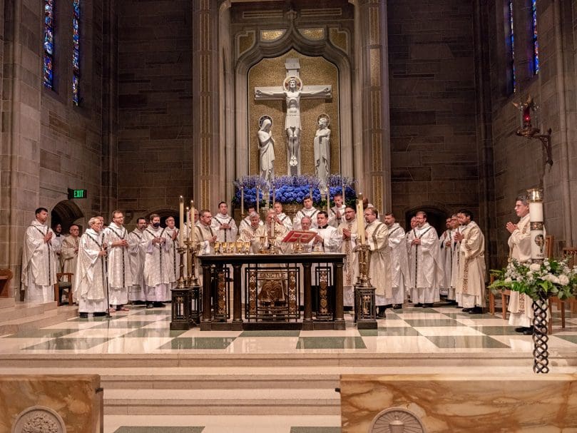 Clergy pray together during the Liturgy of the Eucharist during the Rite of Ordination to the Order of Diaconate held at Atlanta's Cathedral of Christ the King. Photo by Johnathon Kelso