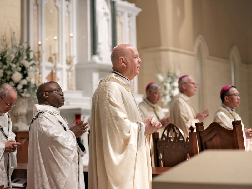 Msgr. Peter Rau sings the opening hymn during the Mass of ordination to the transitional diaconate held at St. Peter Chanel Church in Roswell. Msgr. Rau is the parish's pastor. Photo by Johnathon Kelso