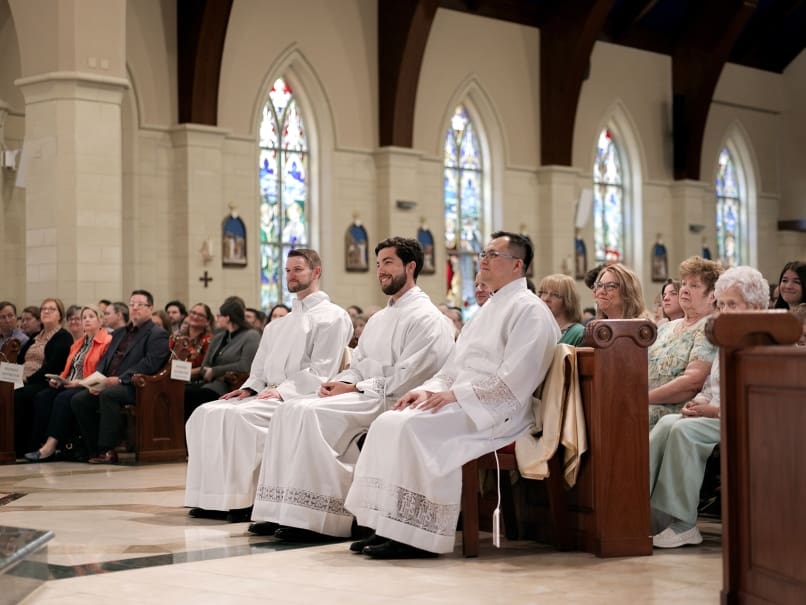 Candidates listen to Archbishop Gregory Hartmayer, OFM Conv., deliver the homily during transitional diaconate ordination at St. Peter Chanel Church. From left to right, David DesPres, Arturo Merriman and Joseph Nguyen. Photo by Johnathon Kelso