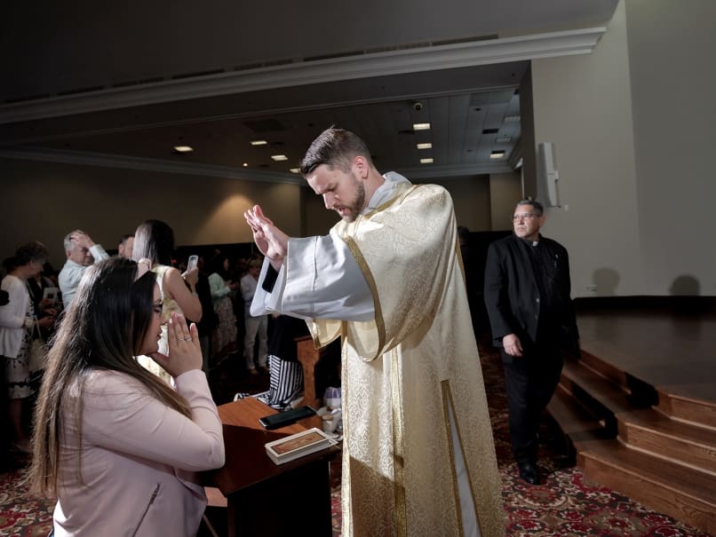 Deacon David DesPres blesses friends and family following the Mass of ordination to the transitional diaconate in Roswell. Photo by Johnathon Kelso