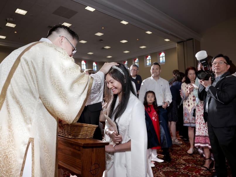 Deacon Joseph Nguyen blesses friends and family following the Mass of ordination to the transitional diaconate May 20 at St. Peter Chanel Church in Roswell. Photo by Johnathon Kelso