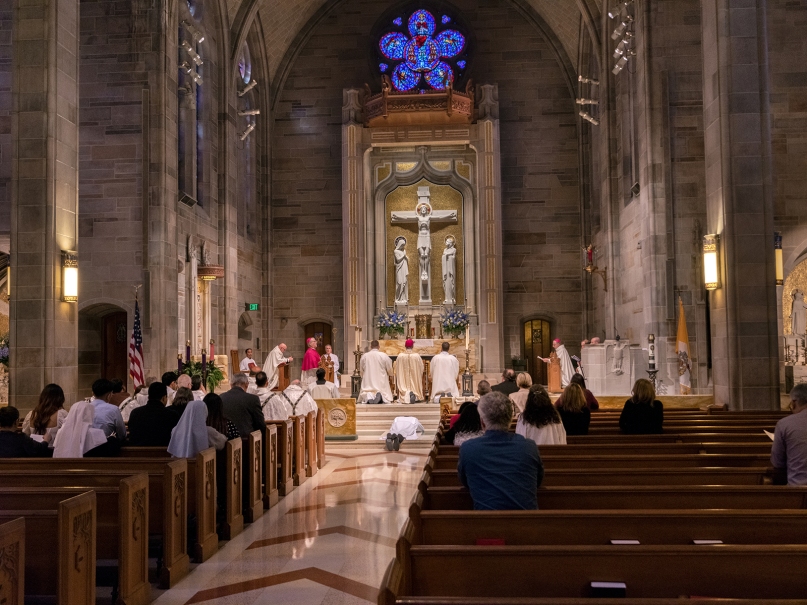 Pete Coppola lies prostrate at the altar during the Litany of Supplication at his ordination as transitional deacon. Photo by Johnathon Kelso