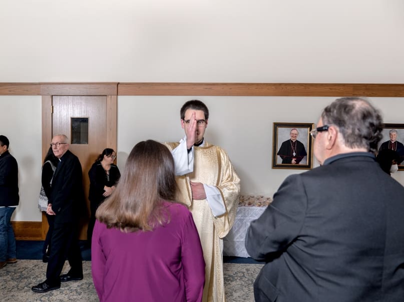 Deacon Pete Coppola gives his first blessing to his parents following ordination to the transitional diaconate. Photo by Johnathon Kelso