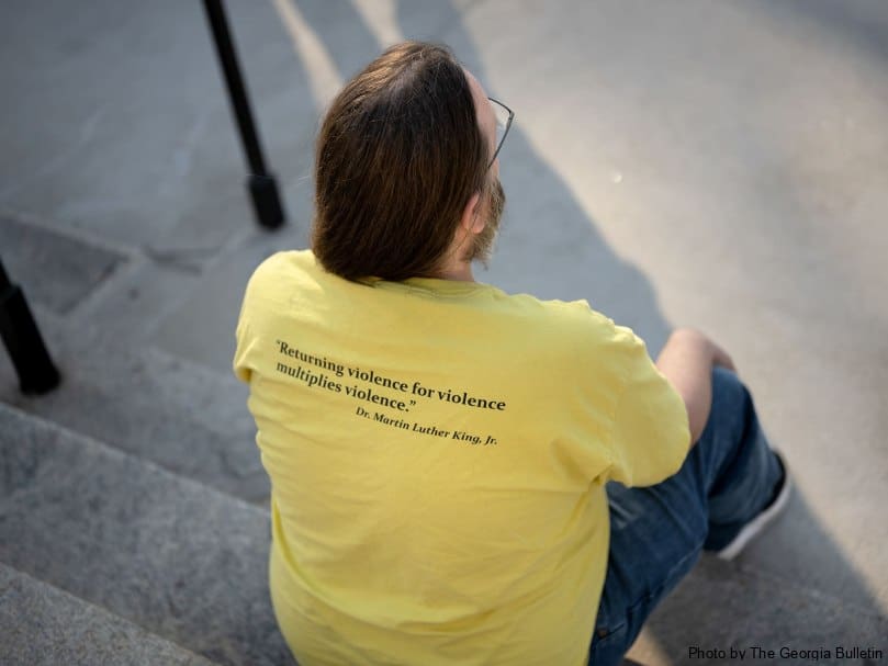 Ben Minor of the Southern Center for Human Rights sits on the steps of the Georgia State Capitol on the evening of the execution of Willie James Pye. Photo by Johnathon Kelso