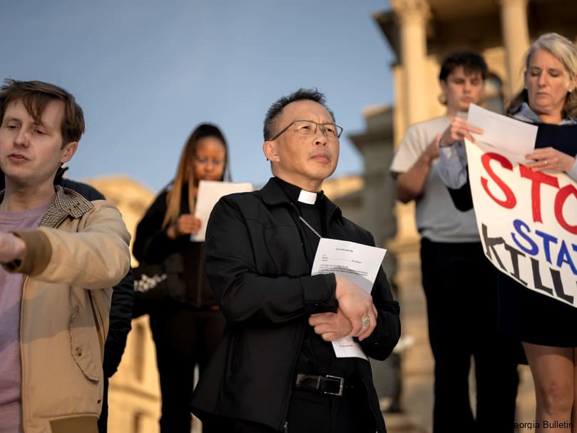Bishop John Nhàn Trần is photographed on the steps of the Georgia State Capitol building during a vigil held for Willie Pye on the evening of his execution. Photo by Johnathon Kelso