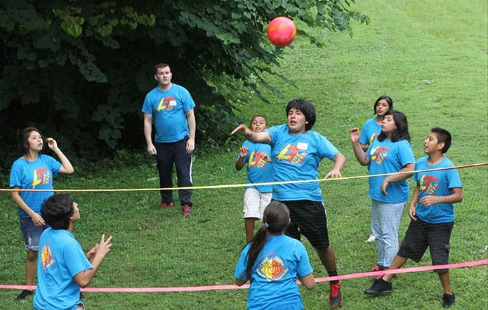 Youth from St. Michael’s Church, Gainesville, play a game of volleyball following a meal of Brazilian cuisine. Photo By Michael Alexander