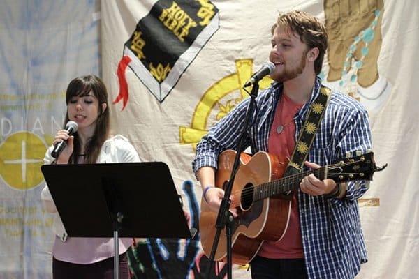 Andrea Merriman, a graduate of the University of Georgia, Athens, and James Perkins, a senior at the University of Georgia, provide the praise music for the July 29 World Youth Day Rally at Holy Family Church, Marietta. Photo By Michael Alexander