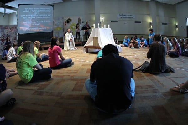 Father Llane B. Briese leads the youth on hand in adoration. Photo By Michael Alexander