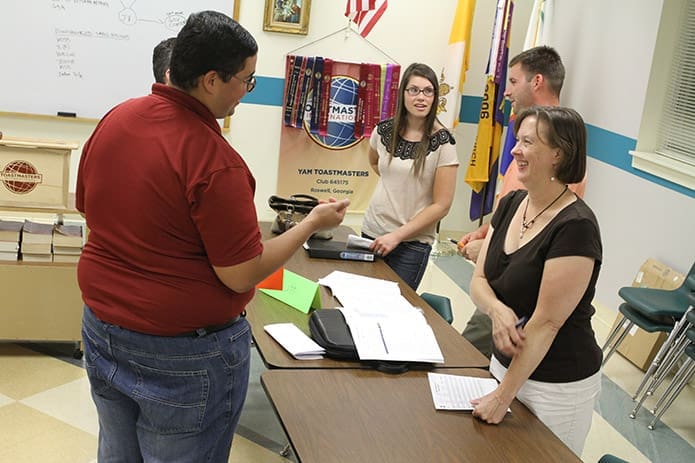 YAM Toastmasters Club members (counter-clockwise from left) Ricardo Cruz, club president, Meghan Riley, Wes Cross, Kelly Akin and Adolfo Ponce de Leon converse with each after the meeting concludes. The Roswell based club is celebrating its 10th anniversary of existence. Photo By Michael Alexander