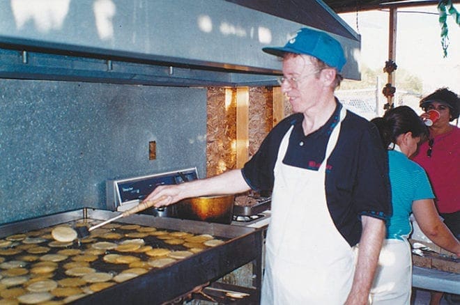 Father Neil Herlihy, then a seminarian, fries gorditas for a parish festival at Santa Lucia Church in El Paso in the summer of 2001. He has initiated Mass in Spanish in The Rock, Ga., where he is pastor. 