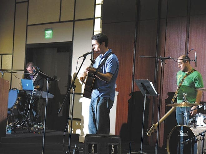 Jon Ferguson, music minister at St. Catherine of Siena Church, Kennesaw, and his band provide the music for Revive’s young adults at the 2013 Eucharistic Congress. 