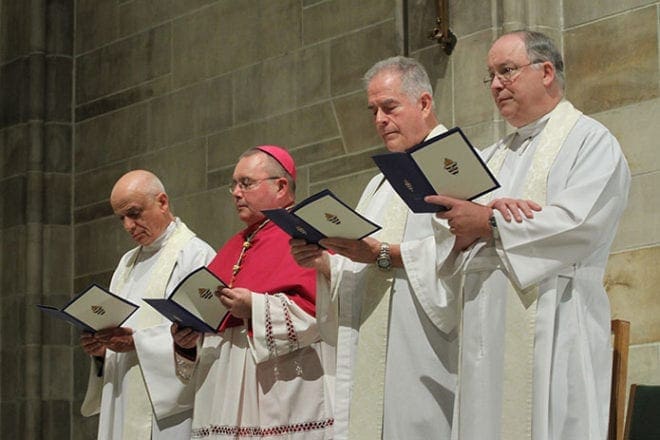 Bishop-designate David Talley, second from left, stands with assisting priests (l-r) Monsignor Frank Giusta, Father Stewart Wilber and Monsignor Dan Stack during the solemn vespers service, April 1.
