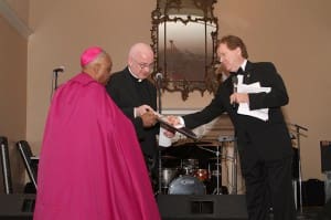 (L-r) Archbishop Wilton D. Gregory and Cathedral of Christ the King pastor Father Frank McNamee accept the City of Atlanta Phoenix Award from Dave Fitzgerald on behalf of Mayor Kasim Reed. 