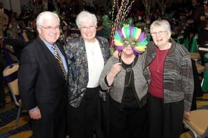 (L-r) Frank Crosby joins Dominican Sisters Elizabeth Sully, Nora Ryan (behind mask) and Patricia Caraher during a moment of fun at the centennial anniversary gala.