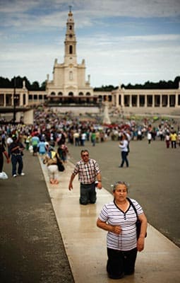 Pilgrims walk on their knees at the Marian shrine of Fatima in central Portugal May 12, 2012. Thousands of pilgrims arrived at the shrine to attend the 95th anniversary of the first apparition of Mary to three shepherd children. Lucia dos Santos and her cousins, Francisco and Jacinta Marto, received the first of several visions of Mary May 13, 1917.