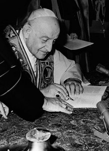 Pope John XXIII signs his encyclical “Peace on Earth” (“Pacem in Terris”) at the Vatican in this 1963 file photo. Considered a highlight in Catholic social teaching, the encyclical addresses universal rights and relations between states.  