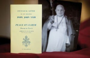 An early edition of the encyclical “Peace on Earth” (“Pacem in Terris”) is pictured next to a photo of its author, Pope John XXIII. The landmark papal letter addressing universal human rights and relations between states marked its 50th anniversary April 11.