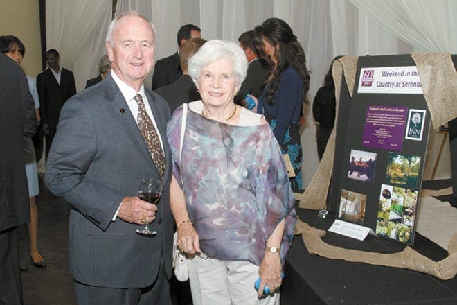 Dennis and Marie Crean of All Saints Church, Dunwoody, walk around bidding on silent auction items during the cocktail reception.